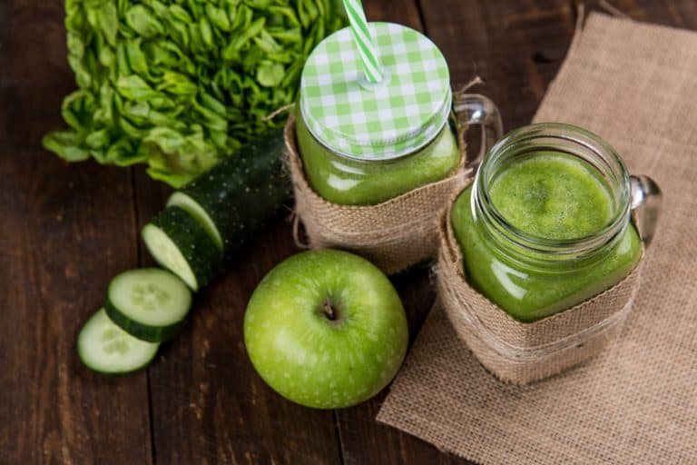 Keto & Gluten-Free Breakfast Ideas. Green Juice with a green apple, and 2 jars of freshly juiced green leady vegetables, cucumbers, and green apples